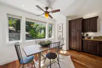 17 _ 21 Nemea Lane _ Breakfast area with dining table and large windows overlooking trees
