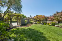 23 _ 21 Nemea Lane _ Landscaped backyard with lawn and garden entry