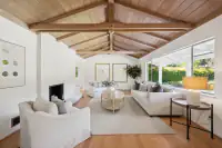 07 - 3435 Black Hawk Road - Living room with fireplace and exposed beam ceiling