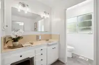 20 - 3435 Black Hawk Road - Primary bathroom with single vanity, large mirror, and separate toilet room