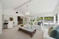 18 - 3435 Black Hawk Road - Sunroom with vaulted ceiling, large windows, sliding glass doors, and garden views