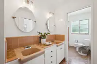 23 - 3435 Black Hawk Road - Guest bathroom with dual vanity, tiled countertops, and separate toilet and shower area