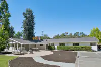 26 - 3435 Black Hawk Road - Rear exterior with expansive patio, landscaped backyard, and private sports court