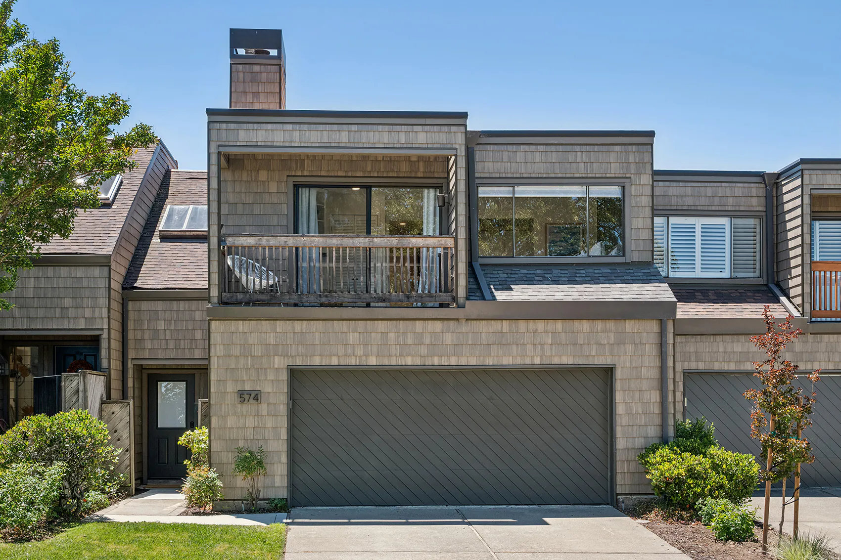 01 - 574 Monarch Ridge Drive - Modern townhouse exterior with an attached two-car garage and private balcony