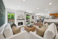 07 - 574 Monarch Ridge Drive - Open-concept living room with fireplace and adjoining dining area