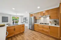 15 - 574 Monarch Ridge Drive - Kitchen with center island, quartz countertops, and stainless steel appliances