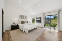 17 - 574 Monarch Ridge Drive - Primary bedroom with vaulted ceiling and private balcony access