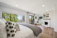 26 - 574 Monarch Ridge Drive - Bedroom with fireplace, private balcony access, and built-in shelving