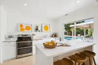 9 _ kitchen-white-cabinets-citrus-artwork-pool-view
