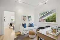 20 _ office-desk-black-chairs-portrait-artwork-plaid-rug