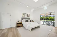 23 _ primary-bedroom-bed-sliding-door-pool-patio-view