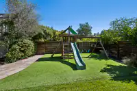 31 _ backyard-wooden-playset-slide-swings-turf-lawn