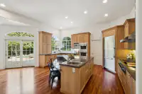 6 _ 2 Reliez Manor Court - Kitchen with large island, wood cabinetry, and stainless steel appliances