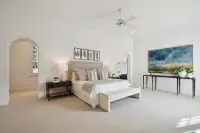 15 _ 2 Reliez Manor Court - Primary bedroom with king-size bed, ceiling fan, and arched doorway