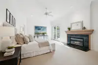 17 _ 2 Reliez Manor Court - Primary bedroom with fireplace, ceiling fan, and French doors to the patio
