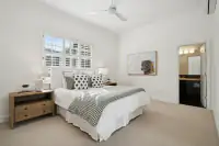 21 _ 2 Reliez Manor Court - Secondary bedroom with bed, nightstands, windows, ceiling fan, and en suite bathroom access