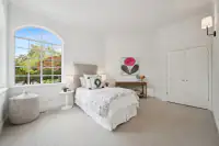 26 _ 2 Reliez Manor Court - Secondary bedroom with bed, nightstands, dresser, closet doors, and large arched window