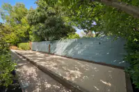 32 _ 2 Reliez Manor Court - Backyard bocce ball court with surrounding landscaping and trees