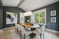 8 _ 31 Sandy Court _ Dining room with oval table, upholstered chairs, pendant lighting, and large windows