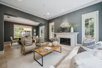 6 _ 31 Sandy Court _ Living room with fireplace, seating area, and adjacent dining room