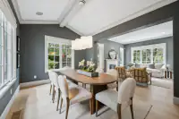 6.1 _ 31 Sandy Court _ Dining room with oval table, upholstered chairs, pendant lighting, and windows overlooking the living room