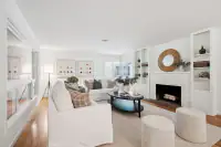 5 _ 808 Rosedale - Living room with sofas, fireplace, built-in shelving, coffee table, and ottomans