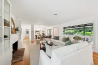 6 _ 808 Rosedale - Living room with sofas, fireplace, built-in shelving, coffee table, and views of the backyard patio
