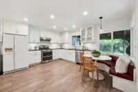 9 _ 808 Rosedale - Kitchen with white cabinetry, stainless steel appliances, breakfast nook, and backyard views