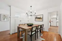 7 _ 808 Rosedale - Dining room with a large dining table, six chairs, pendant chandelier, and built-in storage, with a view into the kitchen