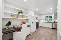 13 _ 808 Rosedale - Kitchen with white cabinetry, built-in desk, open shelving, and stainless steel appliances