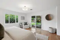 16 _ 808 Rosedale - Spacious primary bedroom with a king bed, sitting area, and direct access to the backyard