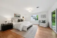 15 _ 808 Rosedale - Bright primary bedroom with a king bed, sitting area, and large windows