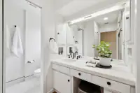 18 _ 808 Rosedale - Bright primary bathroom with a white vanity, large mirror, and private toilet area