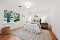 20 _ 808 Rosedale - Bright secondary bedroom with a full-size bed, nightstands, and large windows