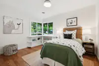 23 _ 808 Rosedale - Bright secondary bedroom with a full-size bed, built-in shelving, and garden views
