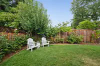 32 _ 808 Rosedale - Private backyard with mature trees, landscaped borders, and Adirondack seating