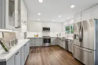5 _ 866 Wilmore Ave _ Kitchen with white cabinetry, countertops, stainless steel appliances, and a window