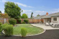 11 _ 866 Wilmore Ave _ Backyard with a lawn, landscaped garden beds, and concrete patio