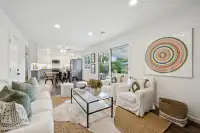 13 _ 866 Wilmore Ave _ Living room with sofas, armchairs, glass coffee table, and large wall artwork