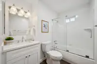 17 _ 866 Wilmore Ave _ Bathroom with a single vanity, toilet, and tub-shower combination