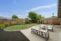 19 _ 866 Wilmore Ave _ Backyard with concrete patio, lawn, outdoor seating, and fenced perimeter