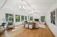 8 _ 3724 Happy Valley Road _ Living room with fireplace and large windows