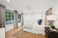 40 _ 3724 Happy Valley Road _ Bedroom with windows and ceiling fan