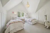 27 _ 1751 Reliez Valley Road _ Bedroom with two twin beds, vaulted ceiling, built-in storage, and dual windows