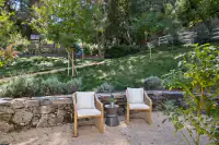 40 _ 1751 Reliez Valley Road _ Outdoor seating area with stone retaining wall, landscaped hillside, and play structure