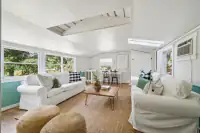 46 _ 1751 Reliez Valley Road _ Living room with two sofas, wood coffee table, dining area, and skylights
