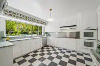 10 _ 3336 Las Huertas _ Kitchen with large window and checkered flooring