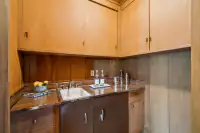 29 _ 3336 Las Huertas _ Office wet bar with sink and storage cabinets