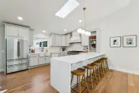 10 - 3208 Camino Colorados _ Kitchen with white cabinetry, island, and bar seating