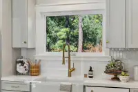 11 _ 3208 Camino Colorados - Kitchen with sink, cabinetry, and window overlooking trees